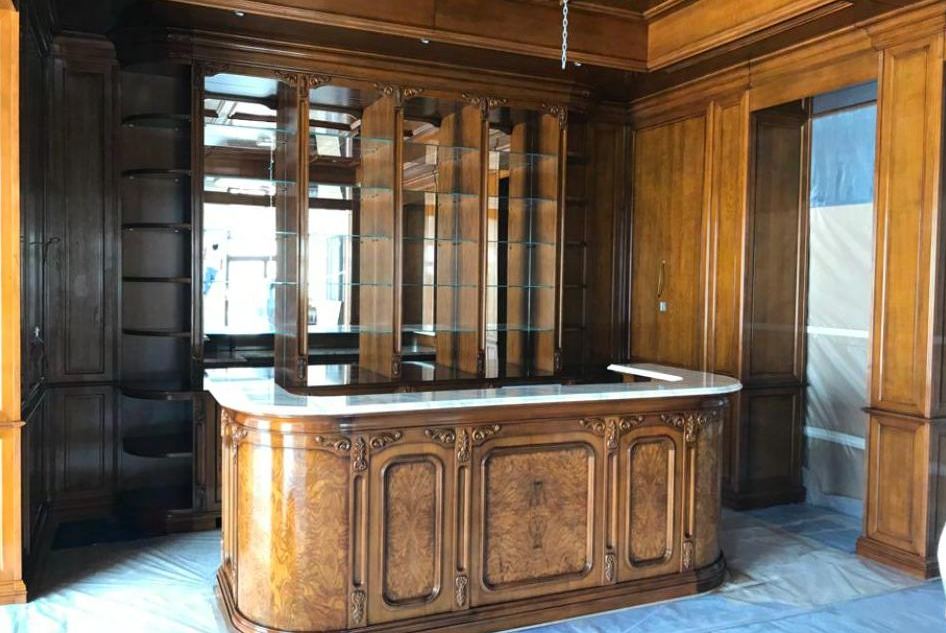 Carved burr-walnut bar and panelled library, Emirates Hills
