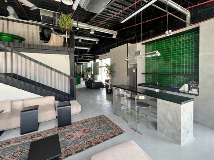 Industrial-style office kitchen and seating area, VICE offices Riyadh