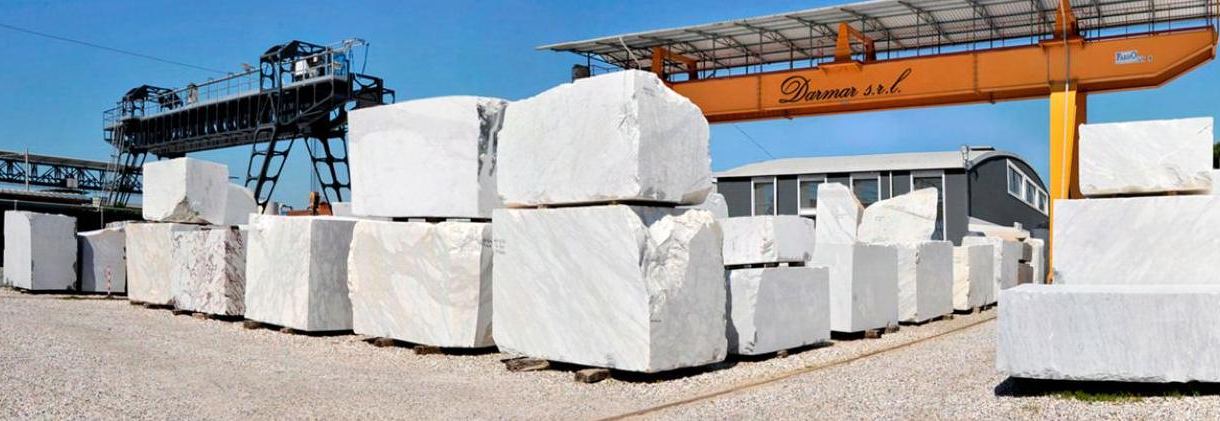 Marble blocks under a gantry crane at a stone yard