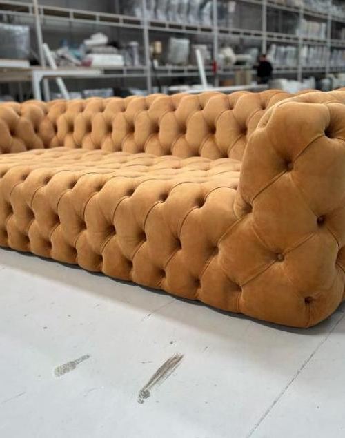 Tufted upholstered sofa on the factory floor before shipment